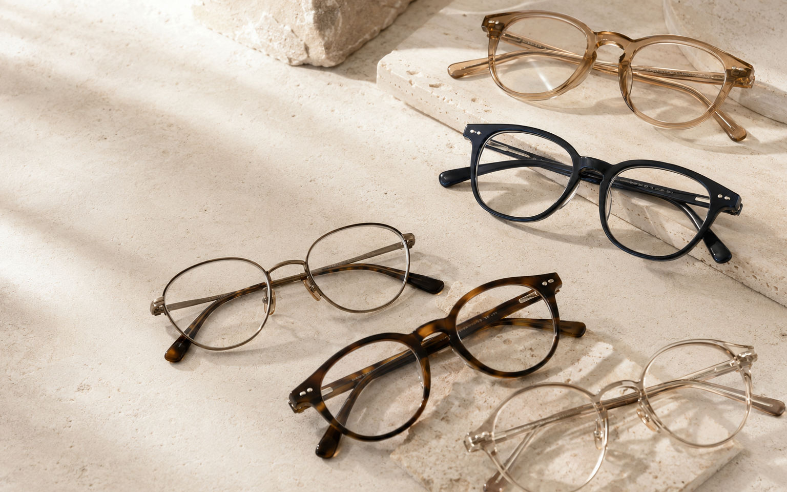 Distinctive eyeglass frames arranged in a warm editorial setting